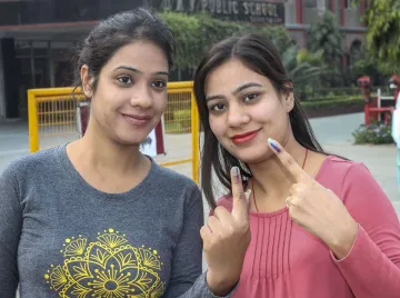 <p>Voters show their inked fingers after casting their...- India TV Hindi