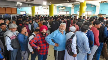 Srinagar: People stand in a queue at a telecom office to restore their mobile phones, in Srinaga- India TV Hindi