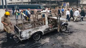 View of a police vehicle after it was burnt down during clashes between lawyers and police personnel- India TV Hindi