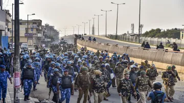 Security personnel conduct flag march during clashes between those against and supporting the Citize- India TV Hindi