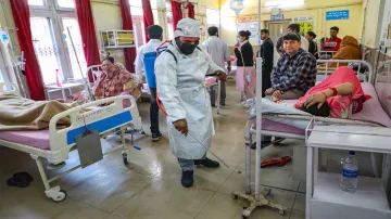 <p>Jammu: A worker sprays disinfectants inside a hospital...- India TV Hindi