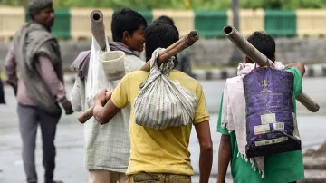 Labourers walk to return to their native places.- India TV Hindi