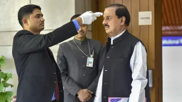 An official uses thermal screening device on BJP leader Mahesh Chandra Sharma at Parliament House in- India TV Hindi
