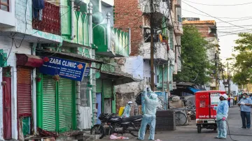 <p>Lucknow: Volunteers spray disinfectants on the building...- India TV Hindi