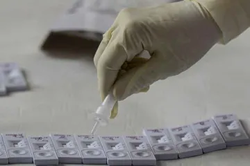 <p>A medic pours a drop of swab sample on a slide for...- India TV Hindi