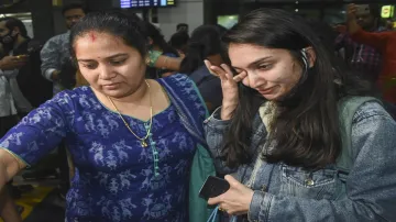 Family members greet an Indian national, evacuated from war-torn Ukraine, upon her arrival at the Bi- India TV Hindi