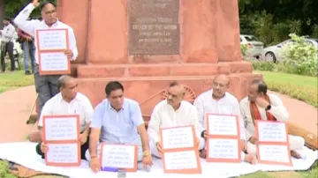 BJP MLAs sitting on Gandhi statue in assembly premises- India TV Hindi