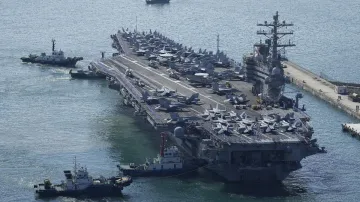 The U.S. carrier USS Ronald Reagan is escorted as it arrives in Busan, South Korea- India TV Hindi
