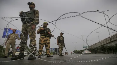 Paramilitary personnel stand guard during restrictions, in Jammu.- India TV Hindi