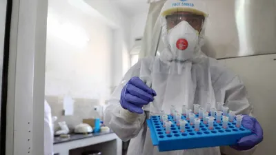 <p>A medic arranges tubes after collecting swab samples for...- India TV Hindi