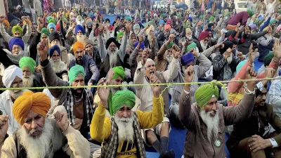 Farmers stage a protest against Centre's farm reform laws at Tikri border, in New Delhi on Thursday.- India TV Hindi