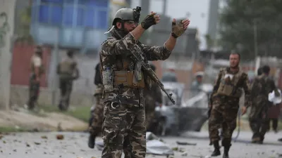 Security personnel inspect a damaged vehicle which was firing rockets in Kabul. (July 20, 2021)- India TV Hindi