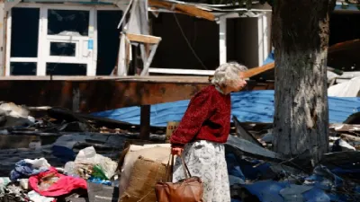 A local civilian walks amid a destroyed building in Ukraine- India TV Hindi