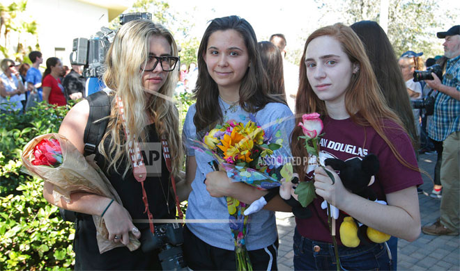 People hold vigil for victims of Florida school shooting | AP Photo People hold vigil for victims of Florida school shooting | AP Photo- India TV