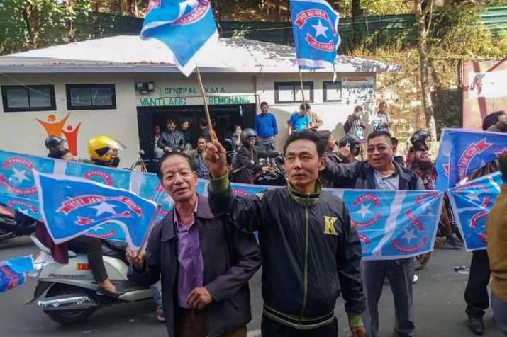 Mizo National Front (MNF) workers hold their party flag... Mizo National Front (MNF) workers hold their party flag...- India TV Hindi