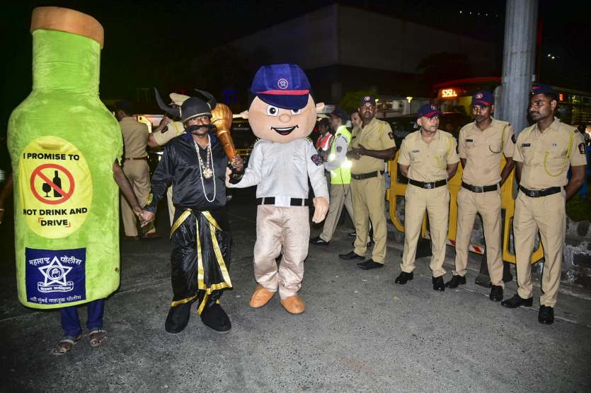 Policemen with mascots during a drive against drunk driving in Navi Mumbai on New Year's Eve