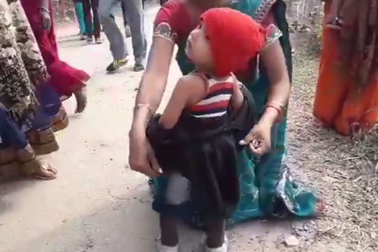 Crying toddler forced to remove black jacket before Sarbananda Sonowal rally Crying toddler forced to remove black jacket before Sarbananda Sonowal rally- India TV Hindi