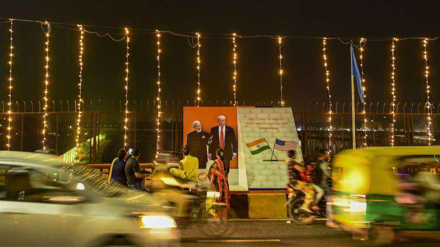 Vehicles drive past a hoarding of Prime Minister... Vehicles drive past a hoarding of Prime Minister...- India TV Hindi