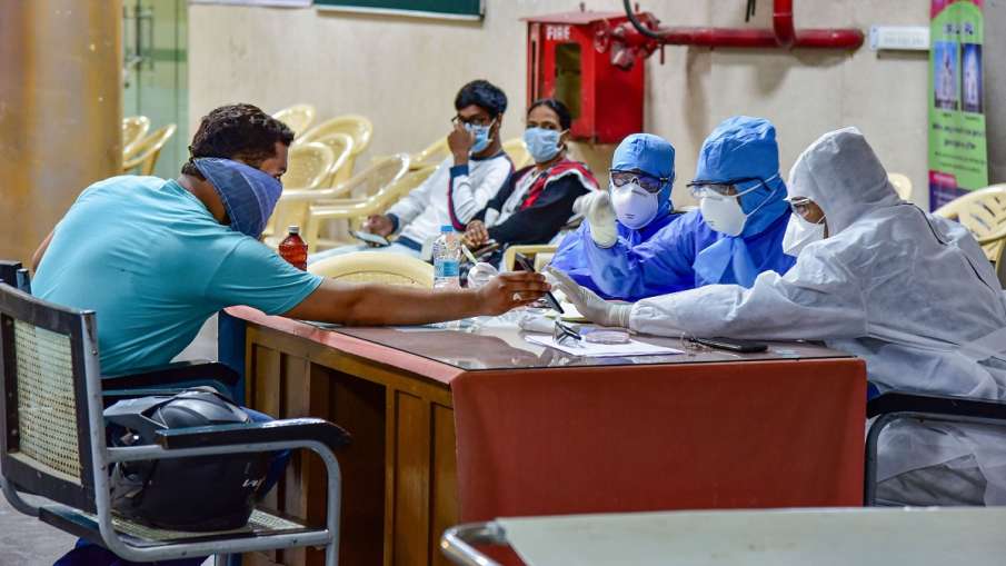 Medics interact with a patient at a help desk, set- up in view of coronavirus pandemic, at Gandhi Ho Medics interact with a patient at a help desk, set- up in view of coronavirus pandemic, at Gandhi Ho- India TV Hindi