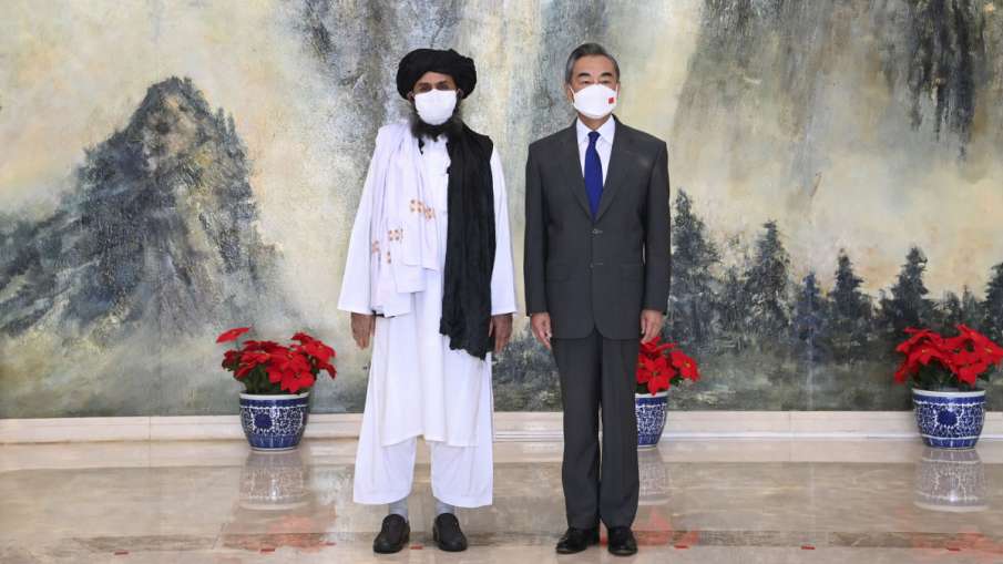 Taliban co-founder Mullah Abdul Ghani Baradar (left) and Chinese Foreign Minister Wang Yi (Right).- India TV Hindi