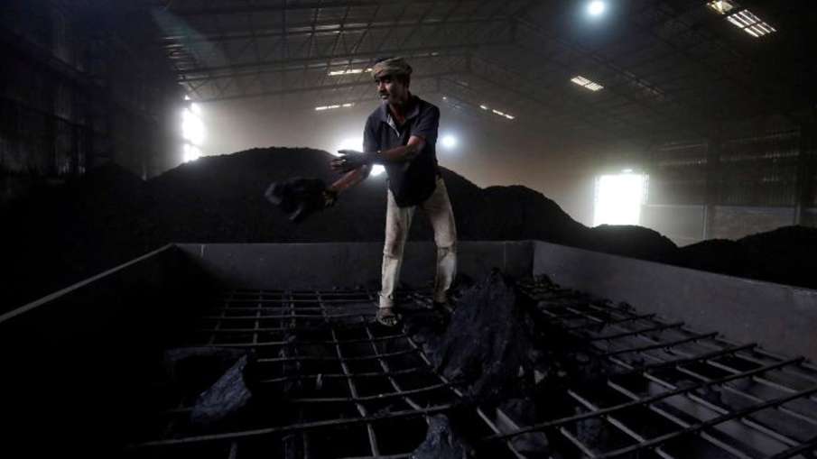 A laborer works inside a coal yard on the outskirts of Ahmedabad, India, in 2017 A laborer works inside a coal yard on the outskirts of Ahmedabad, India, in 2017- India TV Paisa