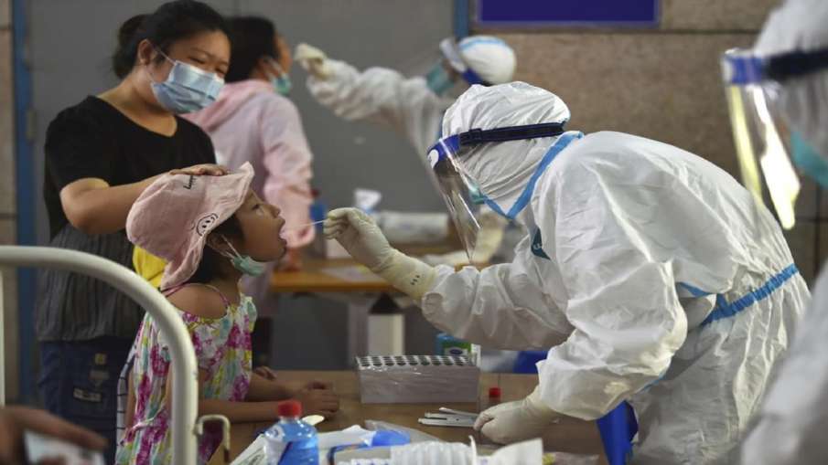 A nurse takes swab samples in the new rounds of Covid-19 testing in Nanjing in eastern China's Jiang- India TV Hindi