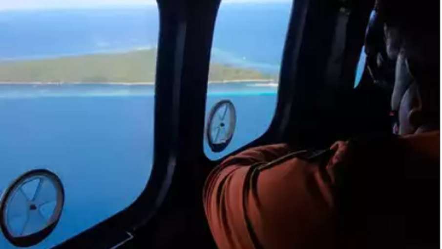 Members of rescue team look out of the windows of helicopter- India TV Hindi